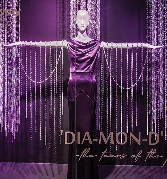 Theme: Purple Reign. Students use strands of crystal beads by the hundreds, combined with dramatic lighting, to evoke a rain-like image celebrating this color trend, and wordplay with purple rain; Class: Design Installation