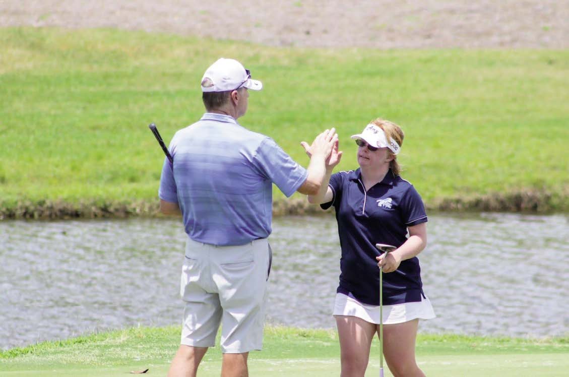 MAN AND GIRL PLAYING GOLF